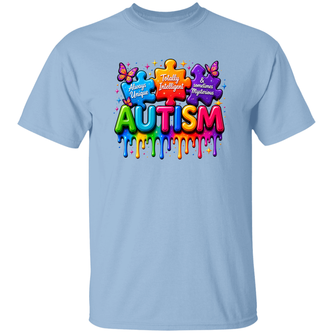 A light blue short-sleeve crewneck t-shirt featuring a colorful graphic on the chest. The graphic displays puzzle pieces and butterflies surrounding the word 'AUTISM' in dripping, rainbow-colored 3D letters, with phrases 'Always Unique', 'Really Intelligent', and 'Sometimes Mysterious' written on the puzzle pieces.