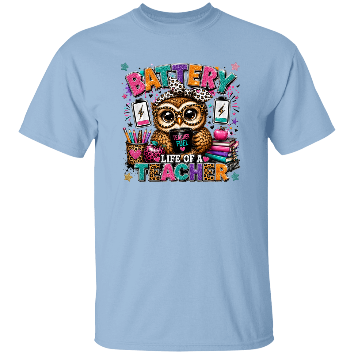 A light blue short-sleeve crewneck t-shirt featuring a colorful graphic of an owl wearing a leopard-print hat, surrounded by school supplies and the text 'BATTERY LIFE OF A TEACHER'.