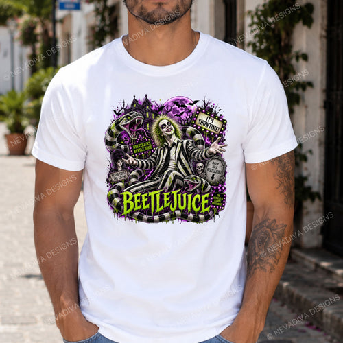 A man wearing a white crewneck t-shirt with a colorful graphic print of Beetlejuice and the Sandworm. The graphic features Beetlejuice in black and white stripes, purple sand, tombstones, and green 'BEETLEJUICE' text.
