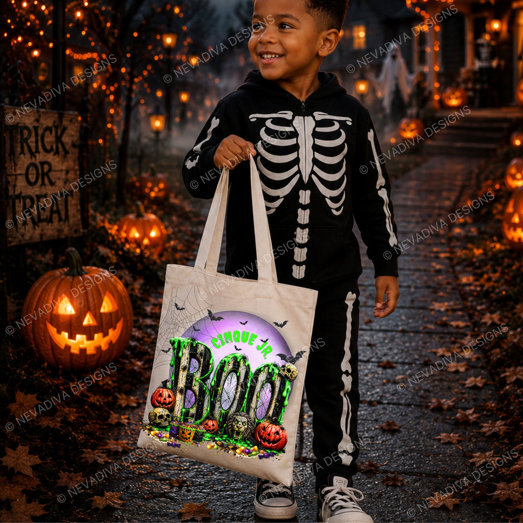 A young boy wearing a black and white skeleton Halloween costume stands on a leaf-covered path at night, holding a white tote bag with a colorful 'BOO' graphic. The background features glowing jack-o'-lanterns, string lights, and a 'Trick or Treat' sign.