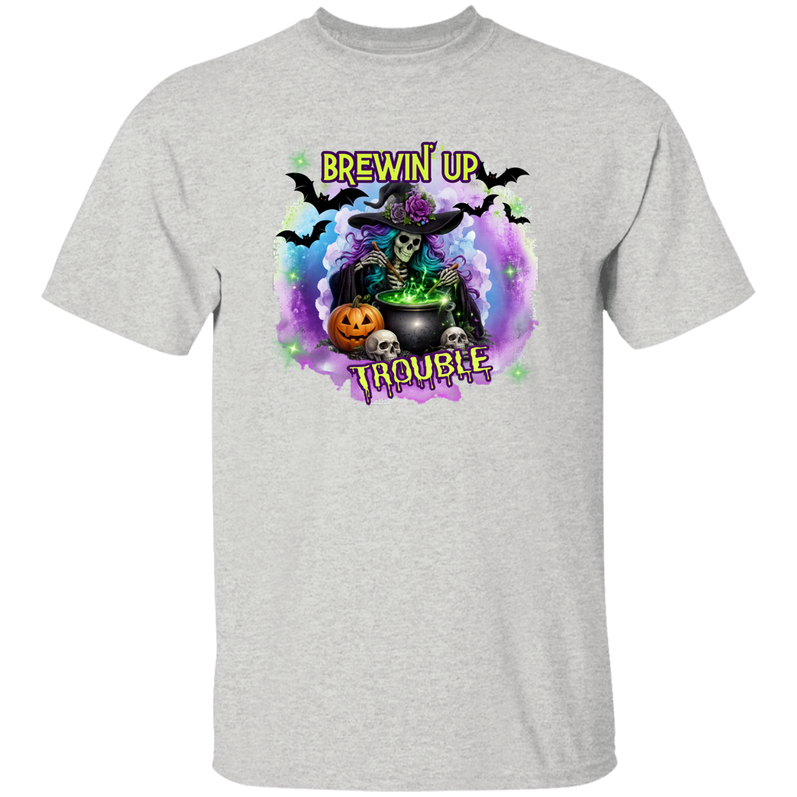 A light heather gray short-sleeve t-shirt with a colorful Halloween-themed graphic on the chest. The graphic features a skeleton in a witch hat sitting by a cauldron with the text 'BREWIN' UP TROUBLE' in stylized yellow and purple lettering, surrounded by bats, a pumpkin, and skulls.