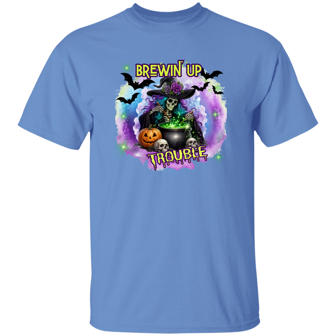 A light blue short-sleeve crewneck t-shirt featuring a colorful Halloween graphic on the chest with a witch, cauldron, bats, skulls, and pumpkins, and the text 'BREWIN' UP TROUBLE'.
