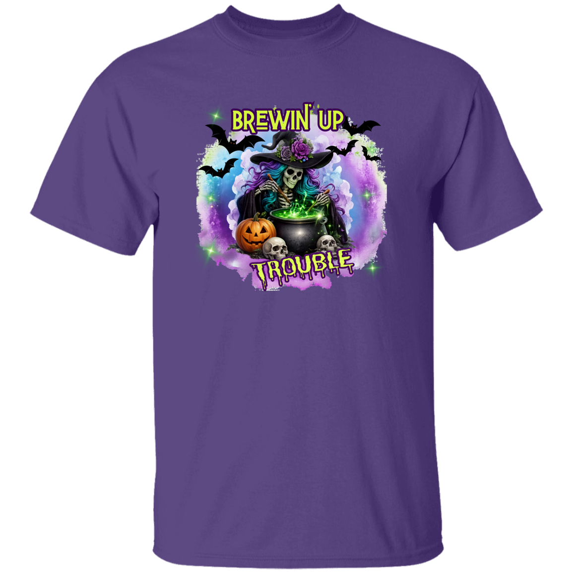 A purple short-sleeve crewneck t-shirt featuring a colorful Halloween graphic of a witch, cauldron, skeleton, pumpkin, skulls, and bats with the text 'BREWIN' UP TROUBLE'.