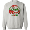 A WHITE Christmas crewneck sweatshirts and red-and-black buffalo plaid pajama pants, standing together in a decorated holiday living room. The sweatshirts feature a festive graphic with 'Merry Christmas' in red and green, and the pants have a classic red and black plaid pattern.