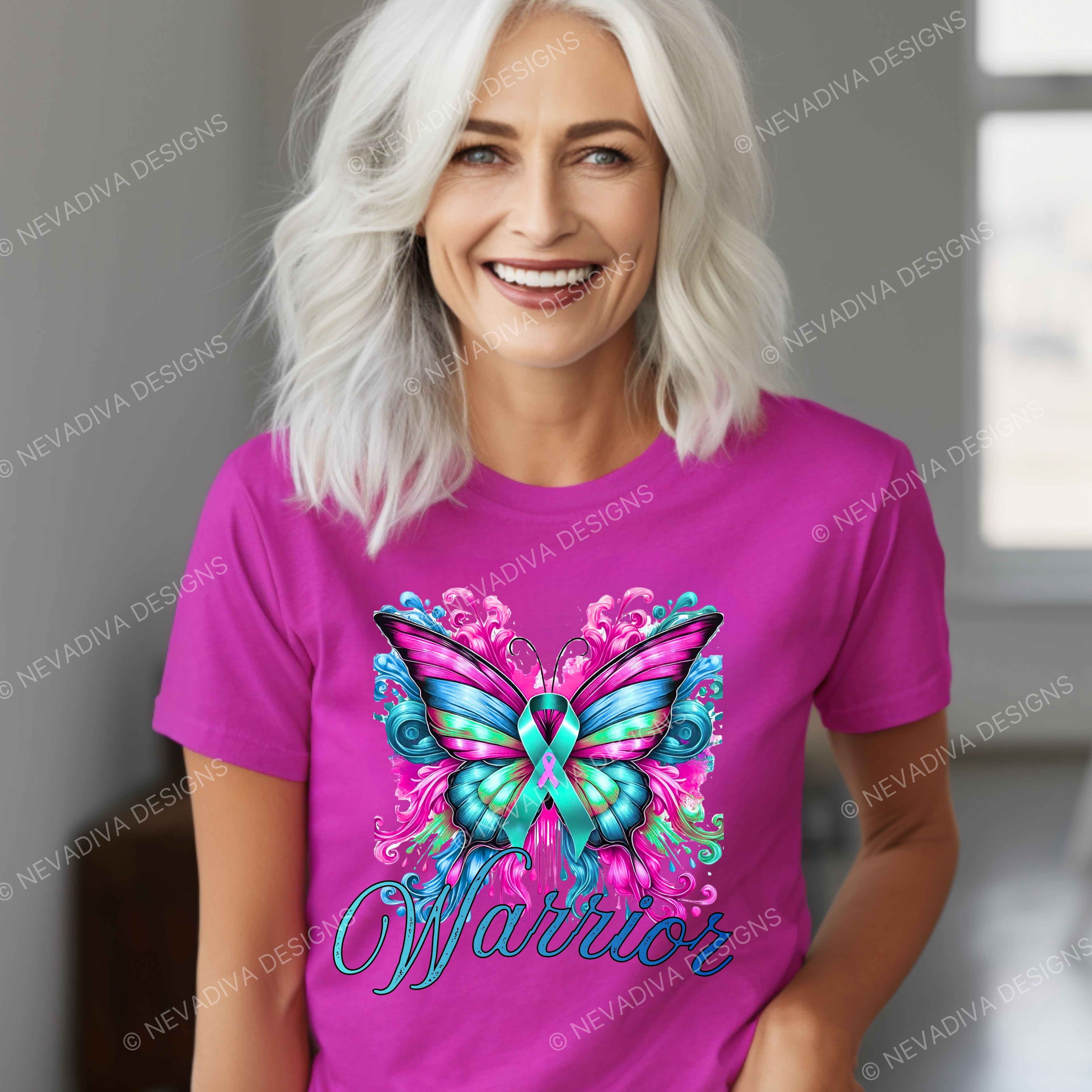 Woman wearing a pink t-shirt with a colorful butterfly design and the word 'Warrior'.
