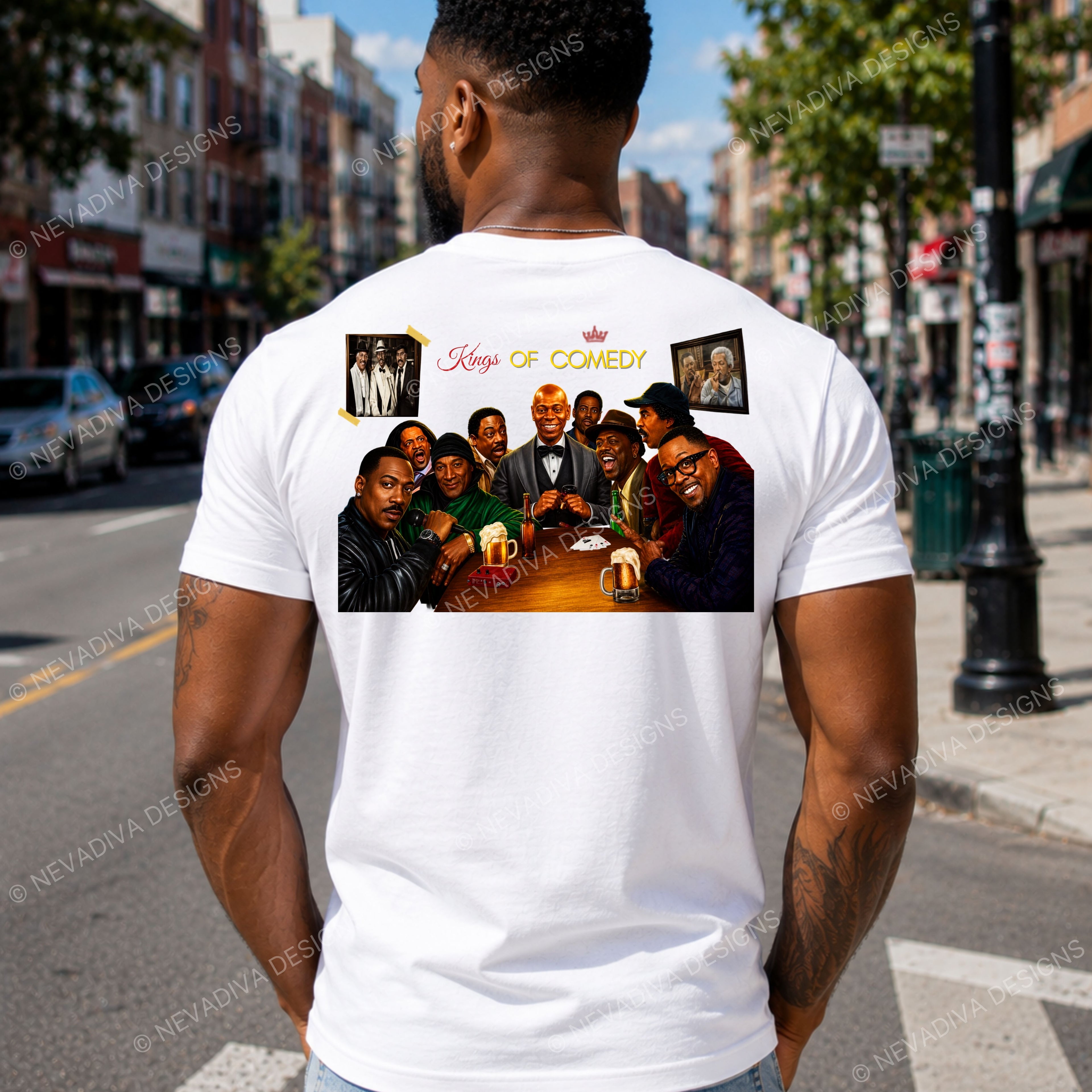 A man viewed from behind wearing a white t-shirt with a large graphic print on the back. The graphic features a group photo of comedians with the text 'Kings of Comedy' and two small portrait frames.