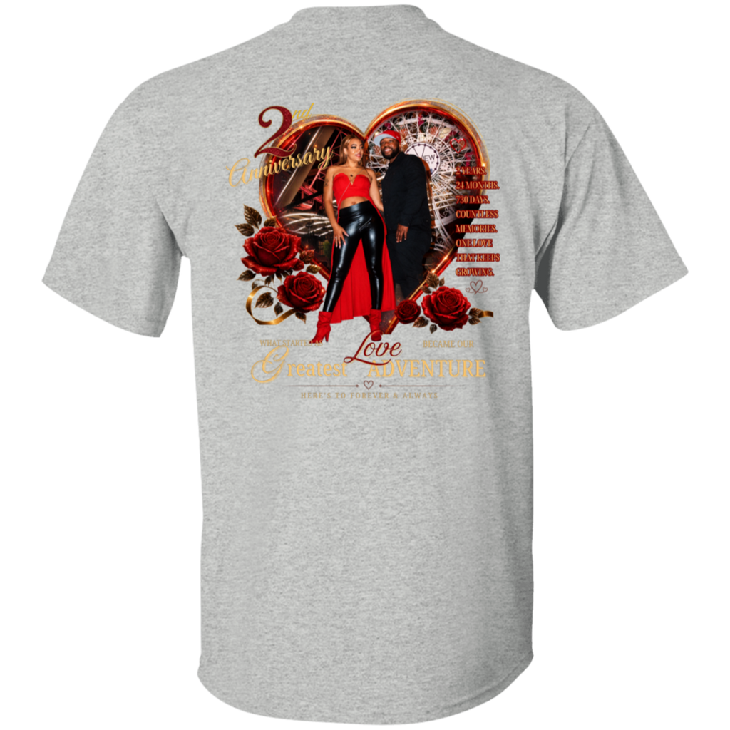 A heather gray short-sleeve t-shirt shown from the back, featuring a large graphic print with a heart, roulette wheel, red roses, a woman in a red dress and black pants, and gold text reading '2 Anniversary' and 'Together We Build a Greater Adventure.'.