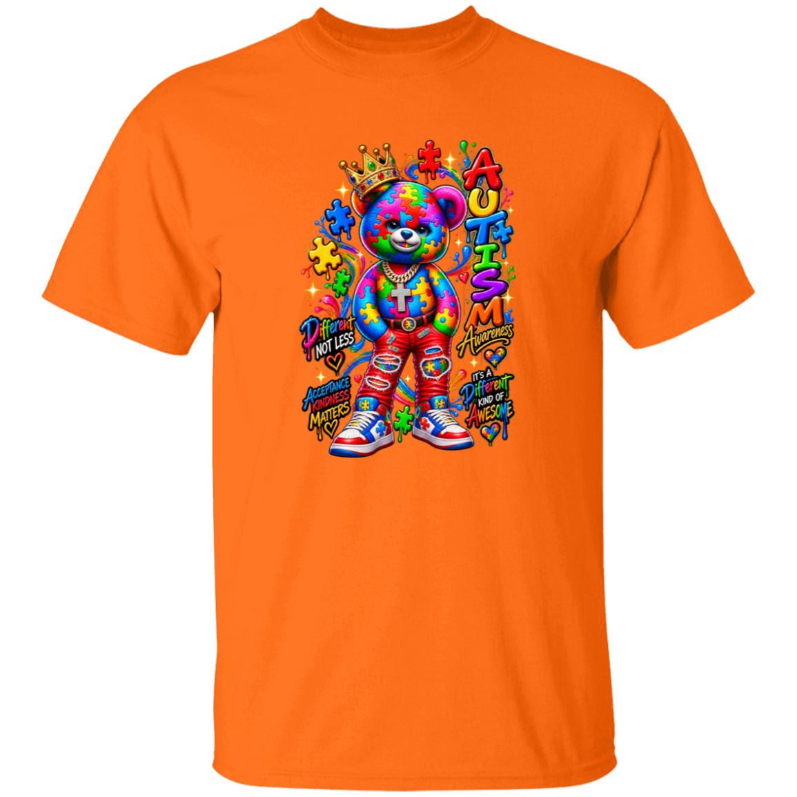 A bright orange short-sleeve crewneck t-shirt featuring a colorful graphic of a teddy bear with a rainbow tie-dye pattern, surrounded by puzzle pieces, a crown, and the word 'AUTISM' in stylized letters.