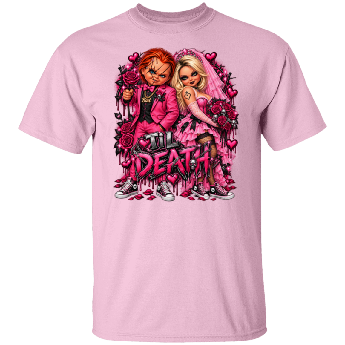 A light pink short-sleeve crewneck t-shirt featuring a large graphic print of Chucky and Tiffany Valentine from Child's Play, styled in a romantic, heart-filled scene with the text 'Till Death'.