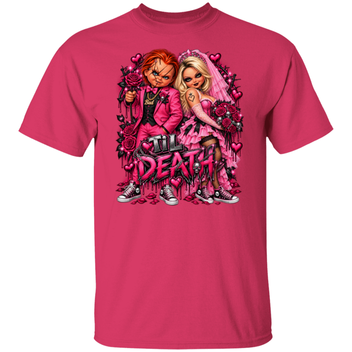 A bright pink short-sleeve crewneck t-shirt featuring a large graphic print of Chucky and Tiffany in pink wedding attire with roses and the text 'I'll DEATH' on the front.