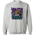 A light gray crewneck sweatshirt featuring a colorful graphic print on the front with the text 'FAITH OVER FEAR' in purple and teal glitter-style lettering, alongside an illustration of a woman in sunglasses.