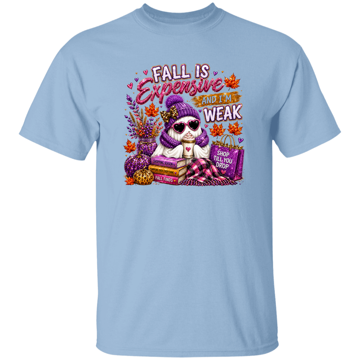 A light blue short-sleeve crewneck t-shirt featuring a colorful graphic print of a ghost wearing a purple beanie and sunglasses, surrounded by fall elements like pumpkins, books, and shopping bags, with the text 'FALL IS Expensive AND I AM WEAK'.