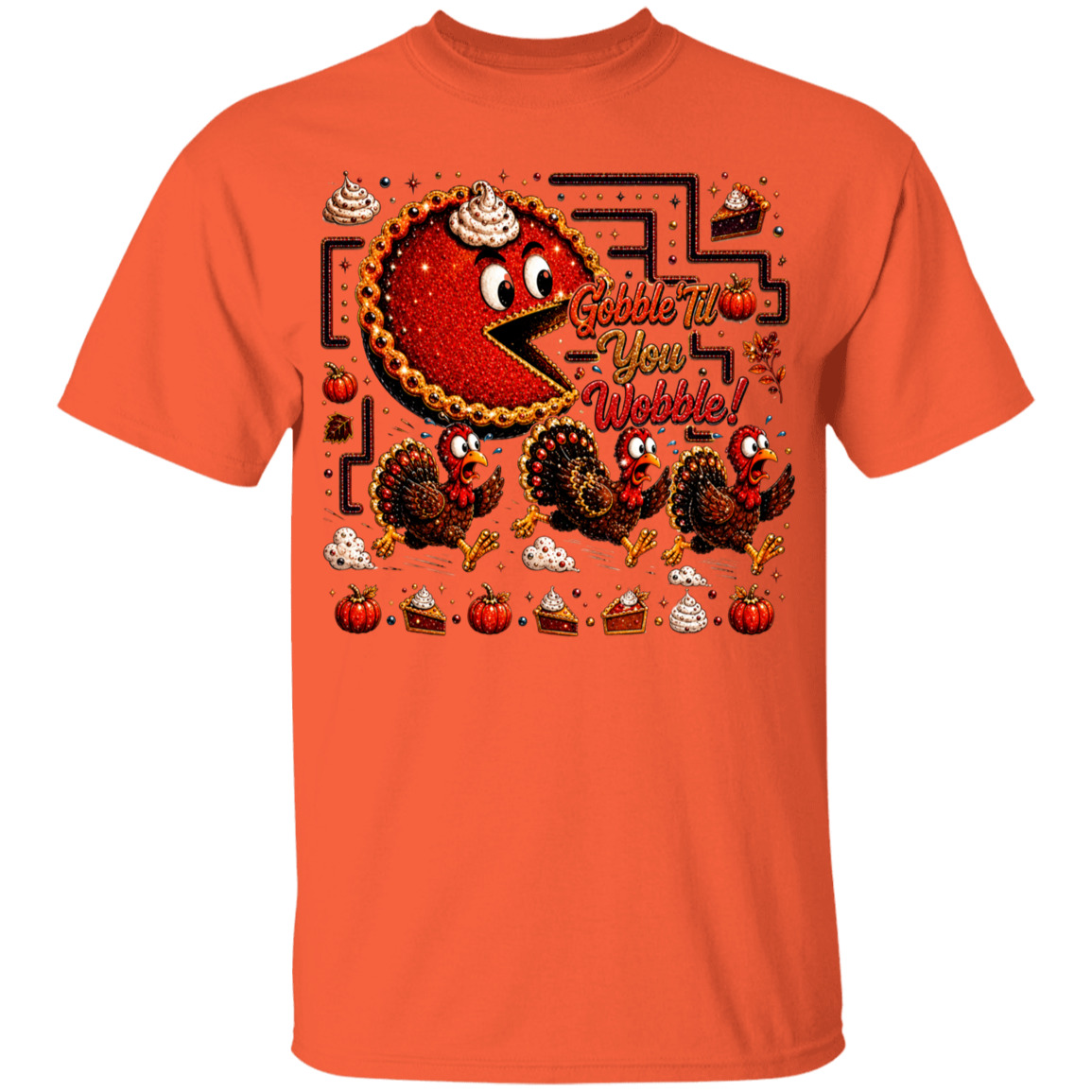An orange crewneck t-shirt featuring a colorful graphic design of a cartoon pie character resembling Pac-Man, with turkeys, pumpkins, slices of cake, and the text 'Gobble Tw- You Wobble!' on a plain white background.
