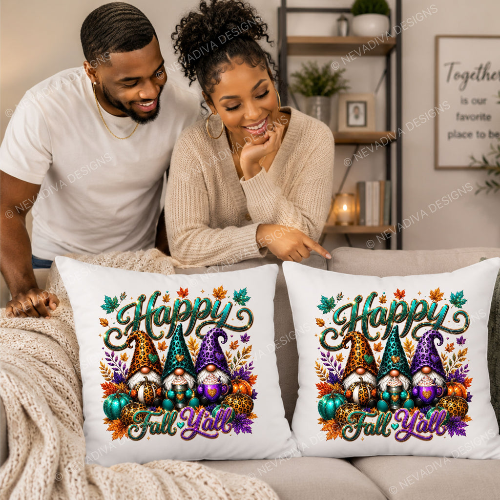 Two white square throw pillows with a colorful 'Happy Fall Y'all' gnome design are displayed on a beige couch in a living room setting, with a couple pointing at them.