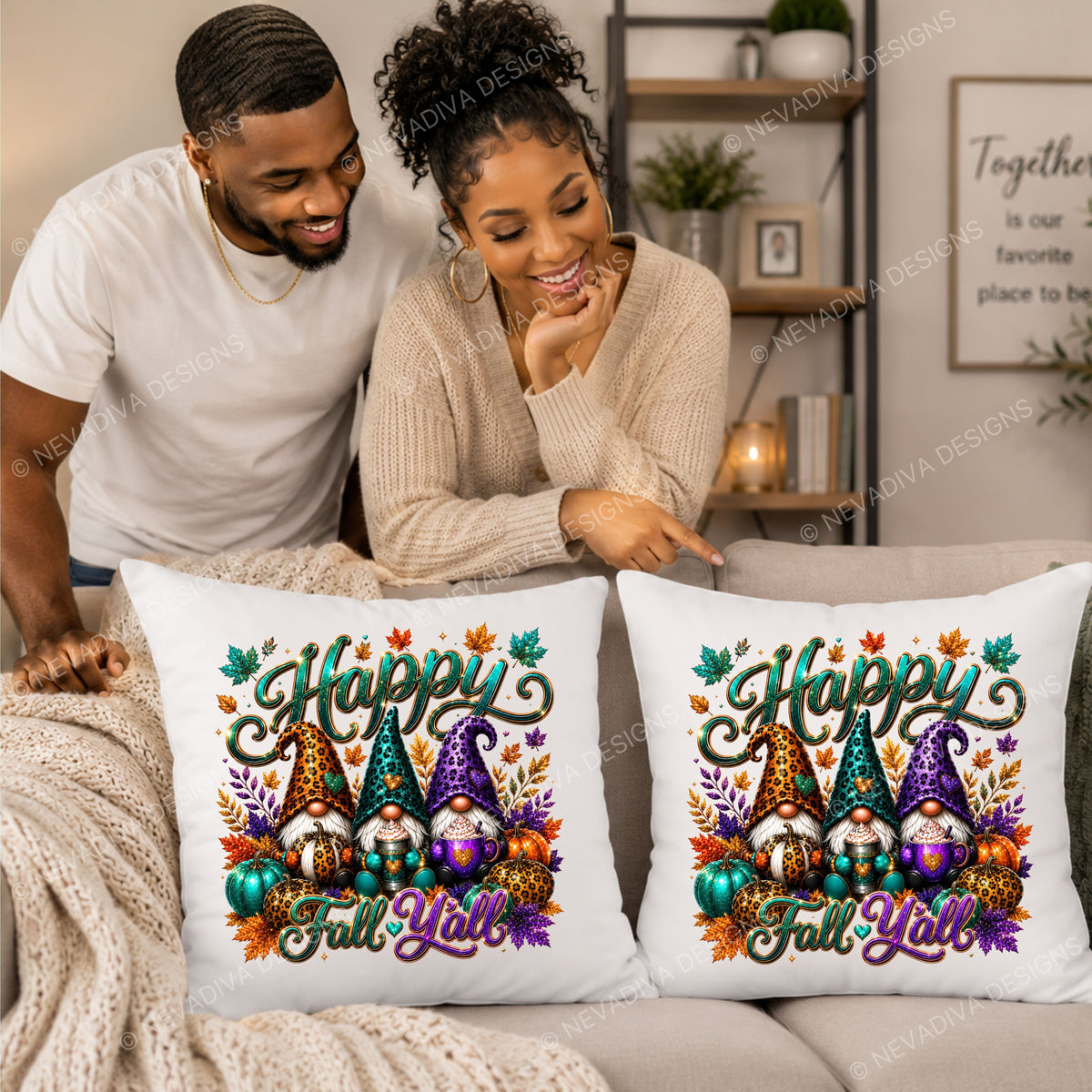 Two white square throw pillows with a colorful 'Happy Fall Y'all' gnome design are displayed on a beige couch in a living room setting, with a couple pointing at them.