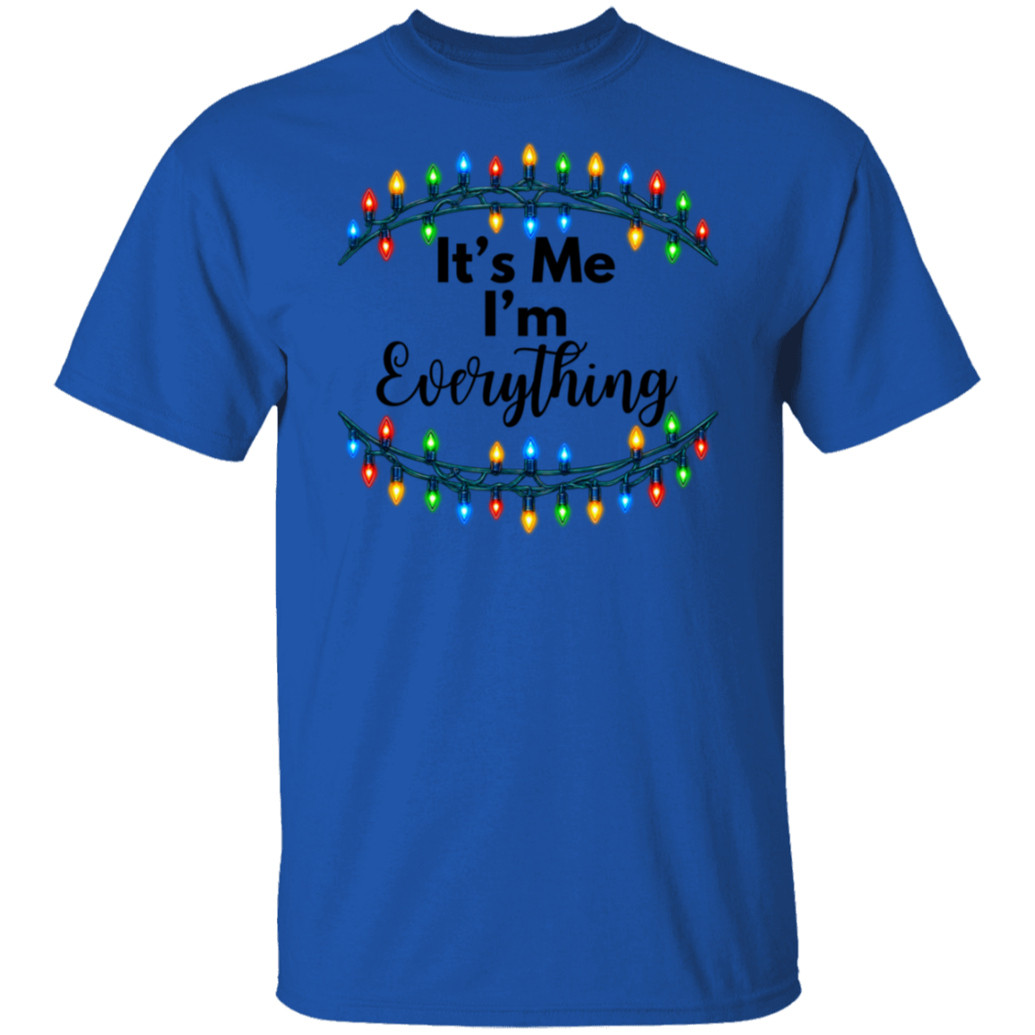 A royal blue short-sleeve t-shirt with a graphic on the chest featuring the text 'It's Me I'm Everything' in black script and print, framed by two curved garlands of multicolored Christmas lights.