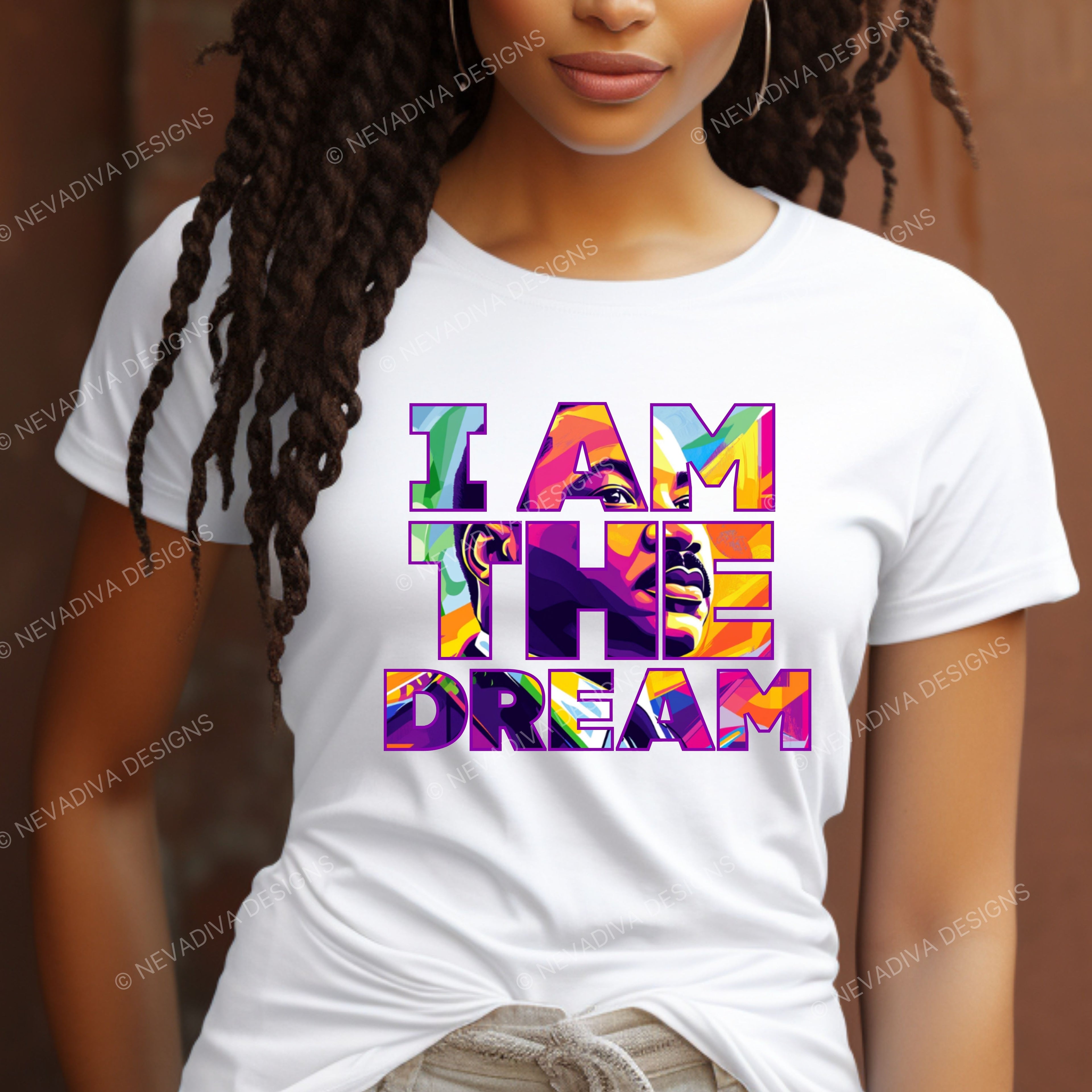 Person wearing a white t-shirt with colorful 'I AM THE DREAM' design.