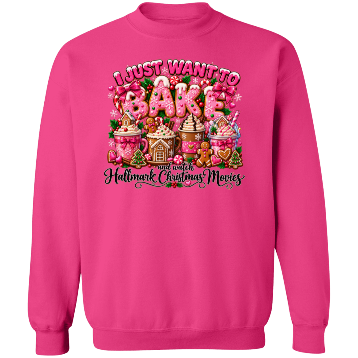 A bright pink crewneck sweatshirt featuring a large, colorful graphic on the chest with the text 'I JUST WANT TO BAKE and watch Hallmark Christmas Movies' and illustrations of gingerbread houses, hot cocoa, and a gingerbread man.