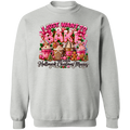 A light gray crewneck sweatshirt featuring a colorful graphic print on the front. The graphic displays the text 'I JUST WANT TO BAKE' in pink and white icing-style lettering above an illustration of hot cocoa mugs, gingerbread houses, and cookies, with the phrase 'and watch Hallmark Christmas Movies' written below in black script.