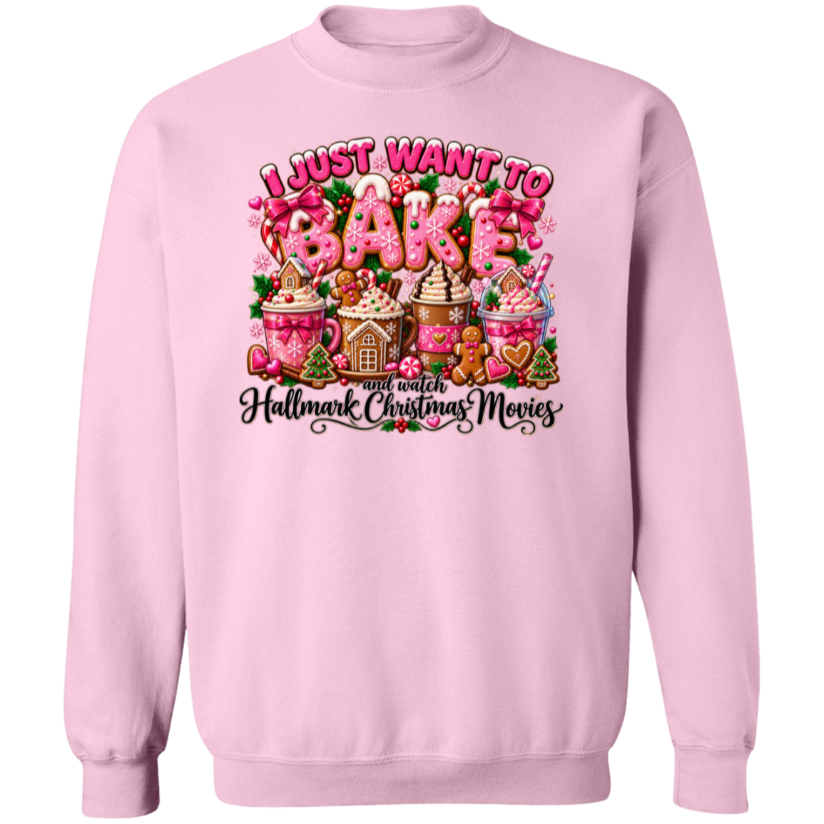 A light pink crewneck sweatshirt featuring a colorful graphic print on the front. The graphic displays the text 'I JUST WANT TO BAKE' in bubbly pink letters above a festive collection of holiday treats, including hot cocoa mugs, gingerbread houses, and a gingerbread man, with 'and watch Hallmark Christmas Movies' written below in black script.
