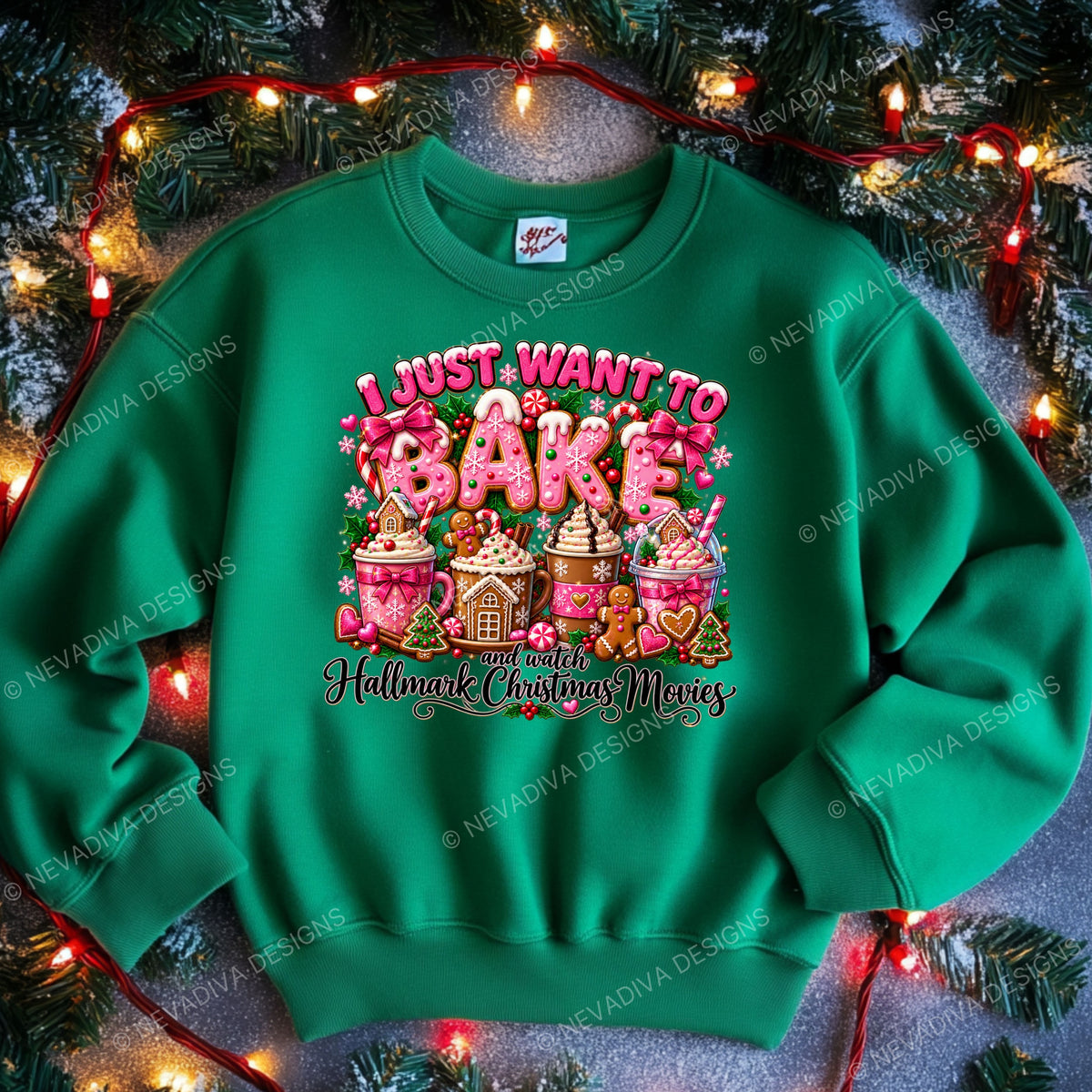A bright green crewneck sweatshirt with a colorful graphic print that reads 'I JUST WANT TO BAKE and watch Hallmark Christmas Movies' surrounded by festive illustrations of holiday treats. The sweatshirt is styled flat on a gray textured surface with pine branches and warm red string lights in the background.