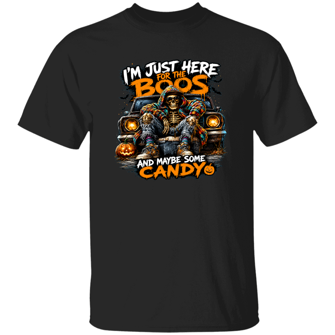 A black short-sleeve crewneck t-shirt featuring a Halloween-themed graphic print of a skeleton in a car with pumpkins and the text 'I'M JUST HERE FOR THE BOOS AND MAYBE SOME CANDY'.