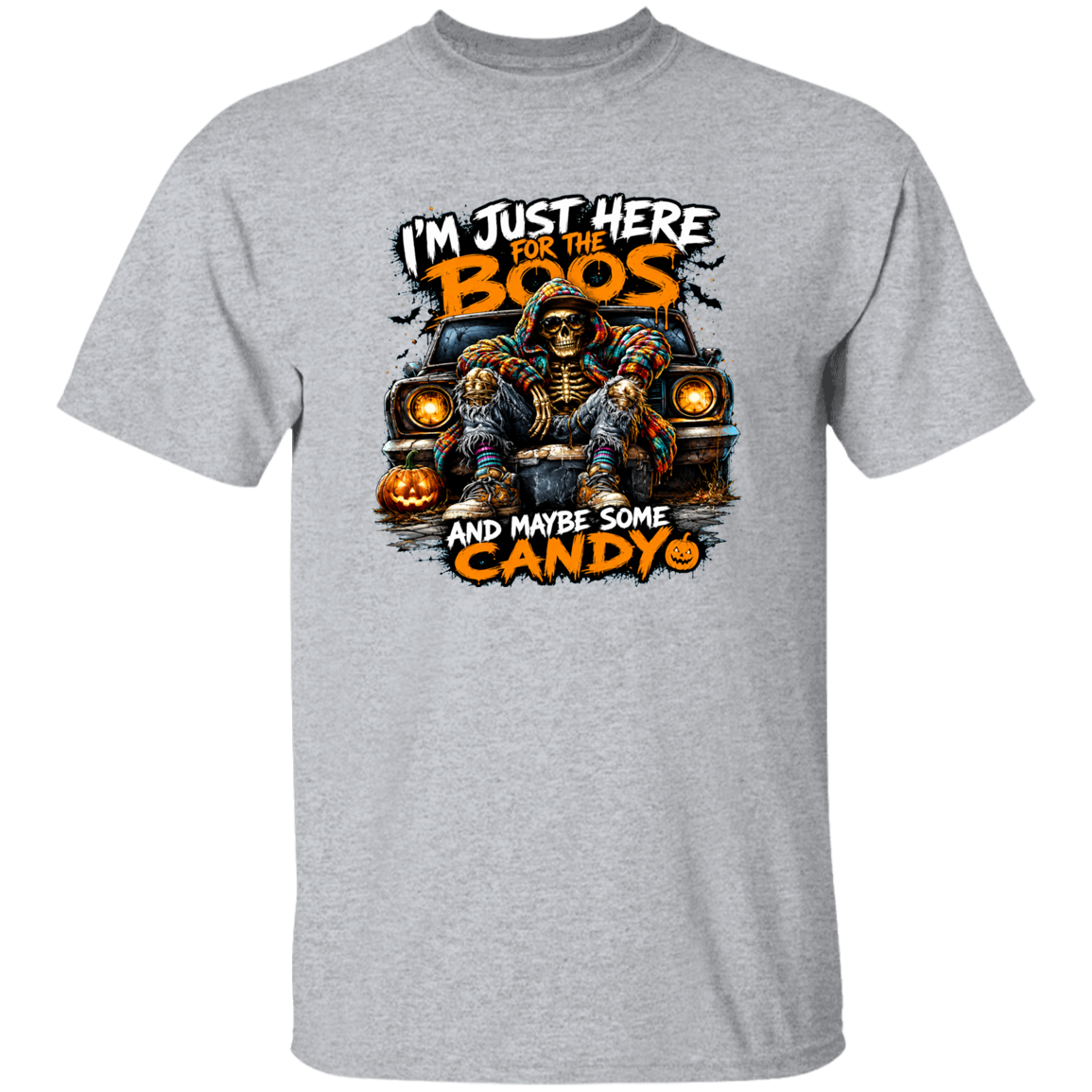 A heather gray short-sleeve crewneck t-shirt featuring a Halloween graphic of a skeleton sitting in a car with pumpkins, with the text 'I'M JUST HERE FOR THE BOOS AND MAYBE SOME CANDY'.