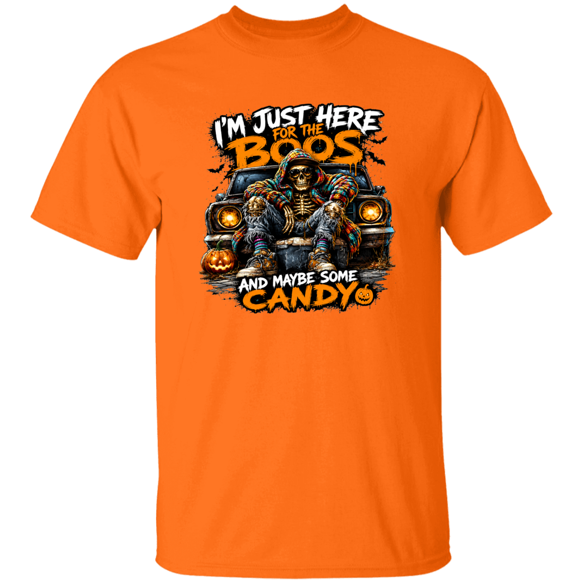 A bright orange short-sleeve crewneck t-shirt featuring a Halloween graphic of a skeleton in a car with the text 'I'M JUST HERE FOR THE BOOS AND MAYBE SOME CANDY'.