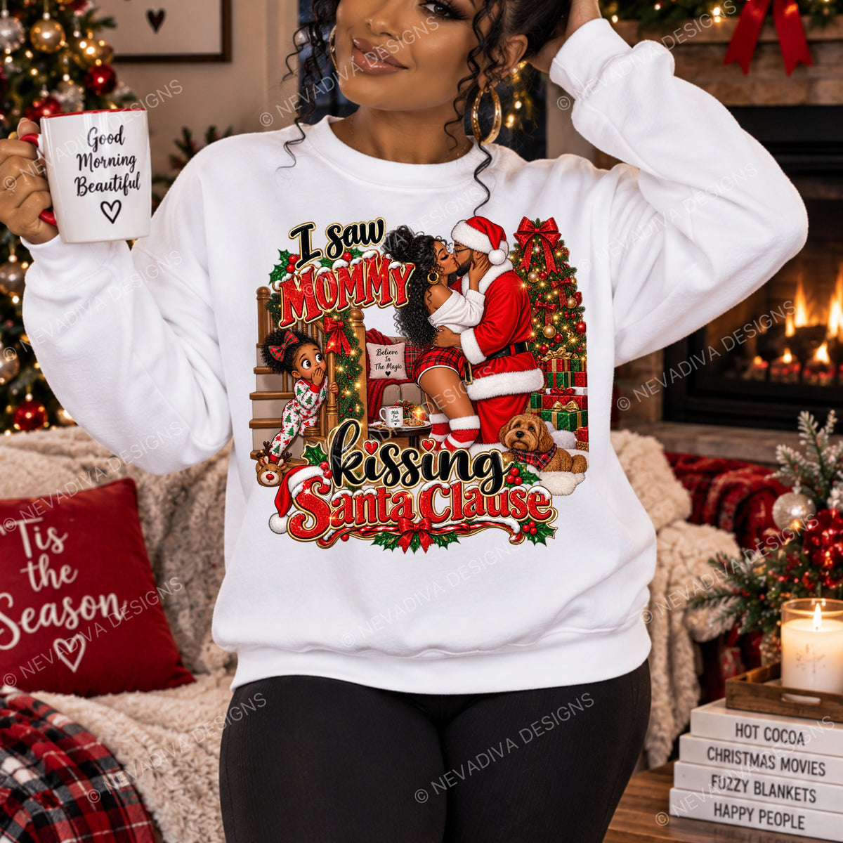 A woman wearing a white crewneck sweatshirt with a large, colorful Christmas graphic that reads 'I saw Mommy kissing Santa Clause' in red and gold lettering. She is holding a white mug that says 'Good Morning Beautiful' and standing in a cozy, decorated holiday living room.
