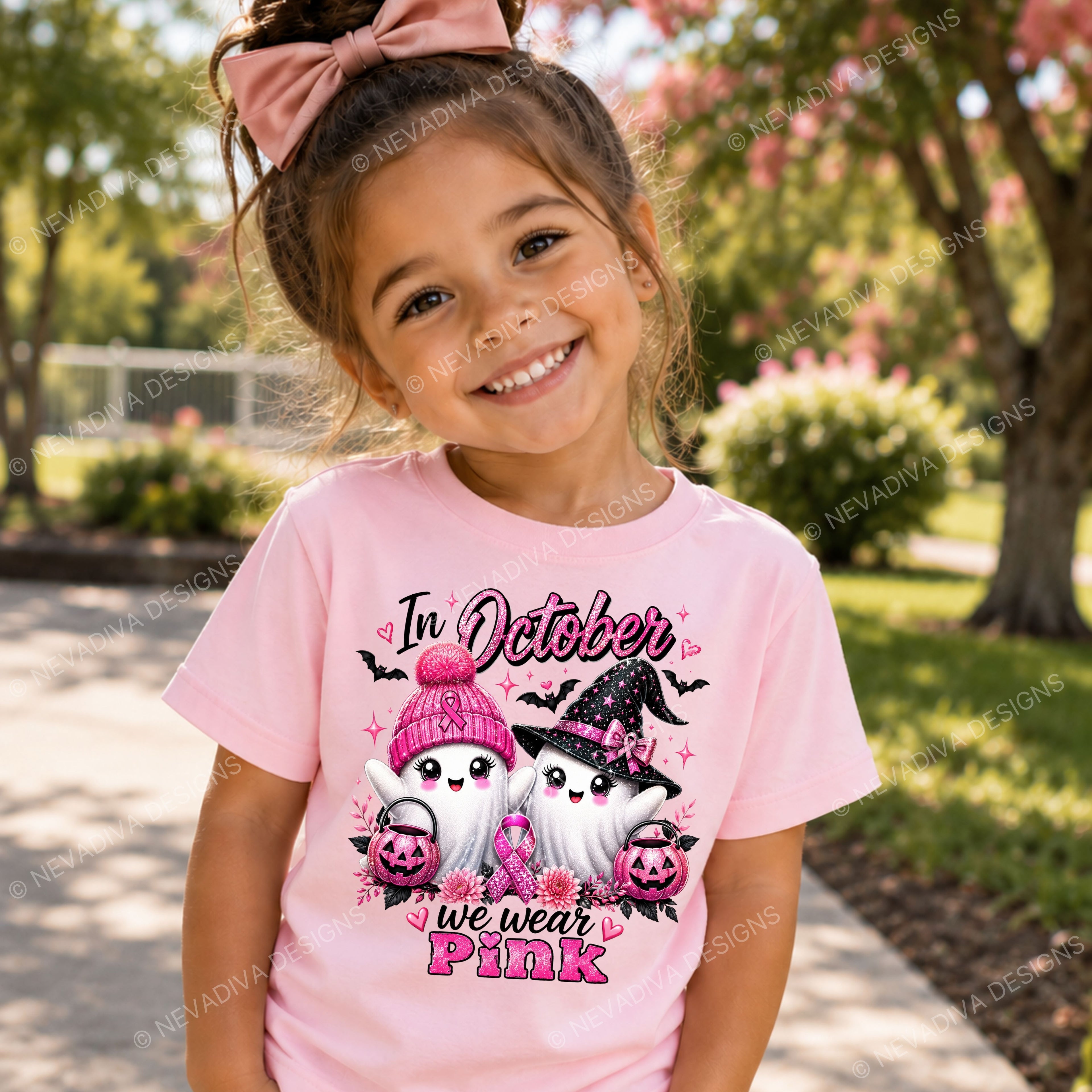 Child wearing a pink t-shirt with ghosts and 'In October we wear Pink' text, standing outdoors.