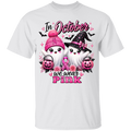 White t-shirt with Halloween-themed design featuring ghosts, pumpkins, and pink ribbons with text 'In October we wear Pink'.
