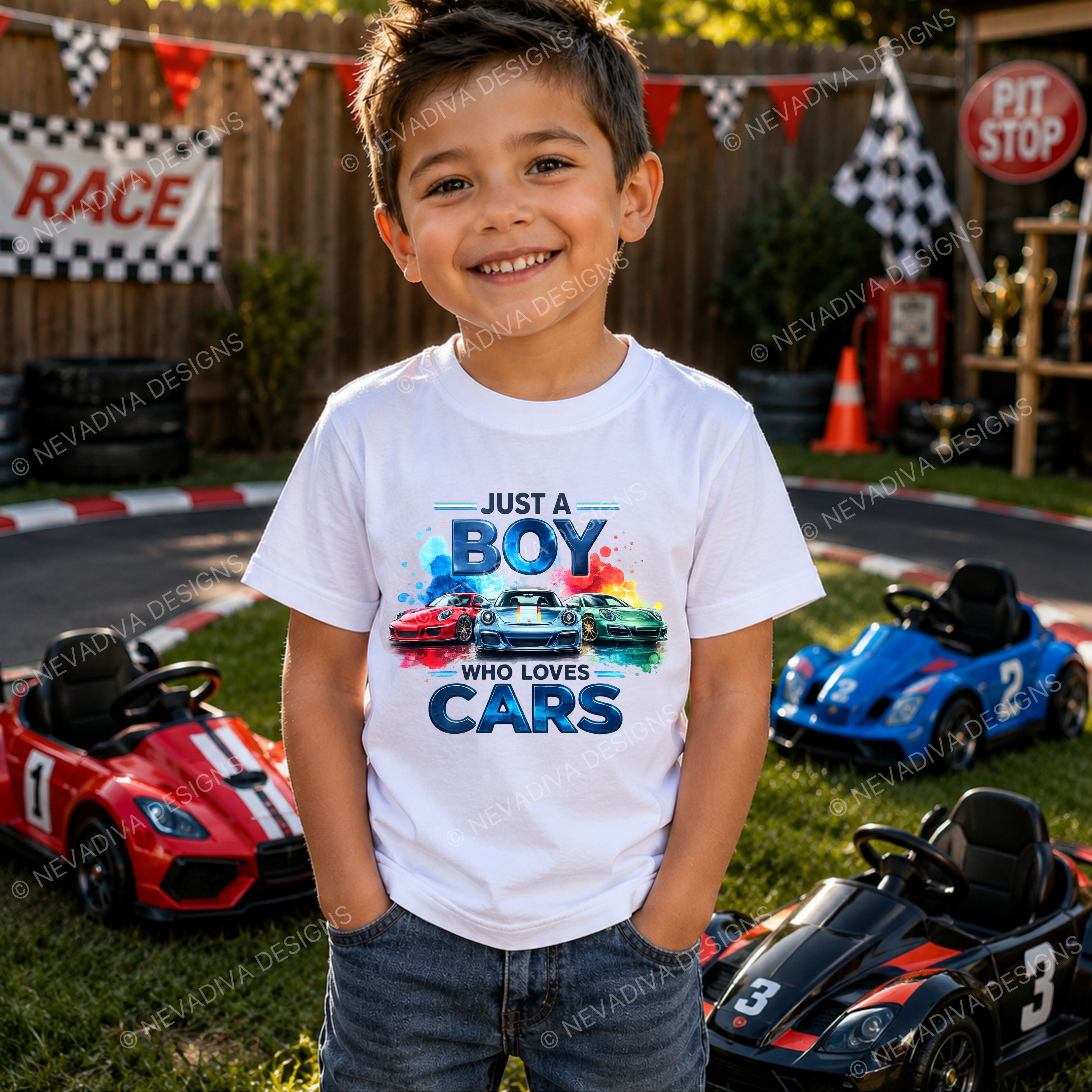 little boy with a white short-sleeve t-shirt with a colorful graphic print on the front. The graphic features the text 'JUST A BOY WHO LOVES CARS' in stylized blue lettering above three sports cars in red, white, and green, set against a clean white background.