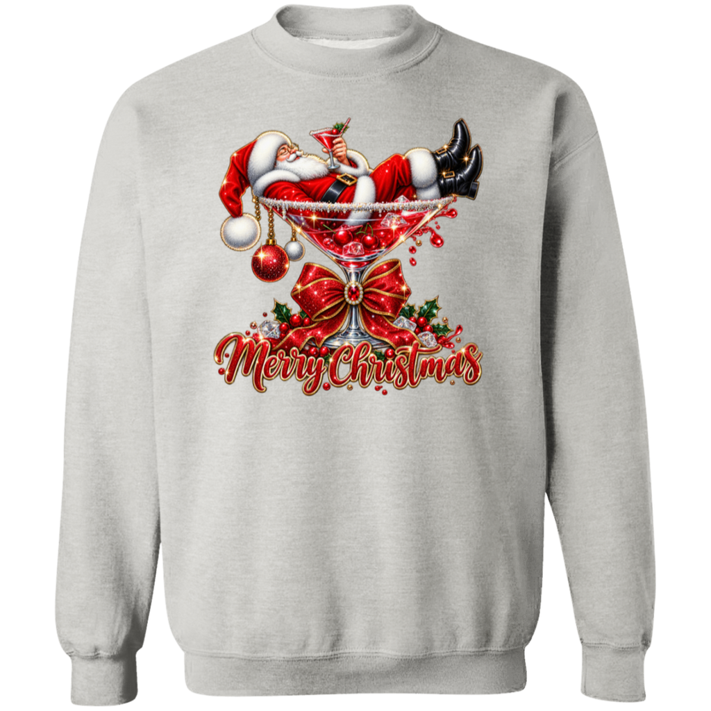 A light gray crewneck sweatshirt featuring a festive Christmas graphic on the front. The design shows Santa Claus lounging in a martini glass with red ornaments, a large red bow, holly, and the text 'Merry Christmas' in red script.