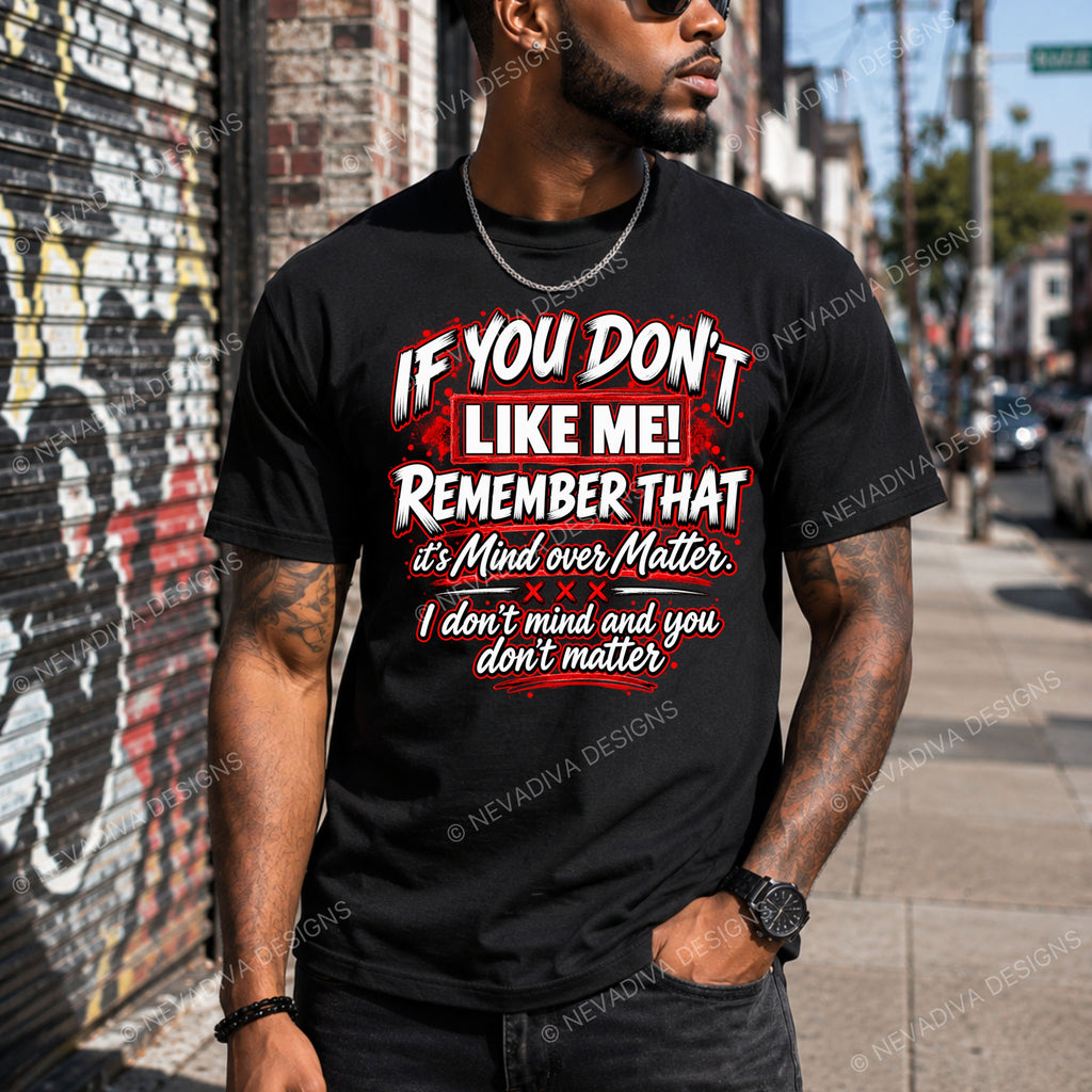 A man wearing a black graphic t-shirt with a bold white and red text design that reads 'IF YOU DON'T LIKE ME! REMEMBER THAT it's Mind over Matter. I don't mind and you don't matter!'.