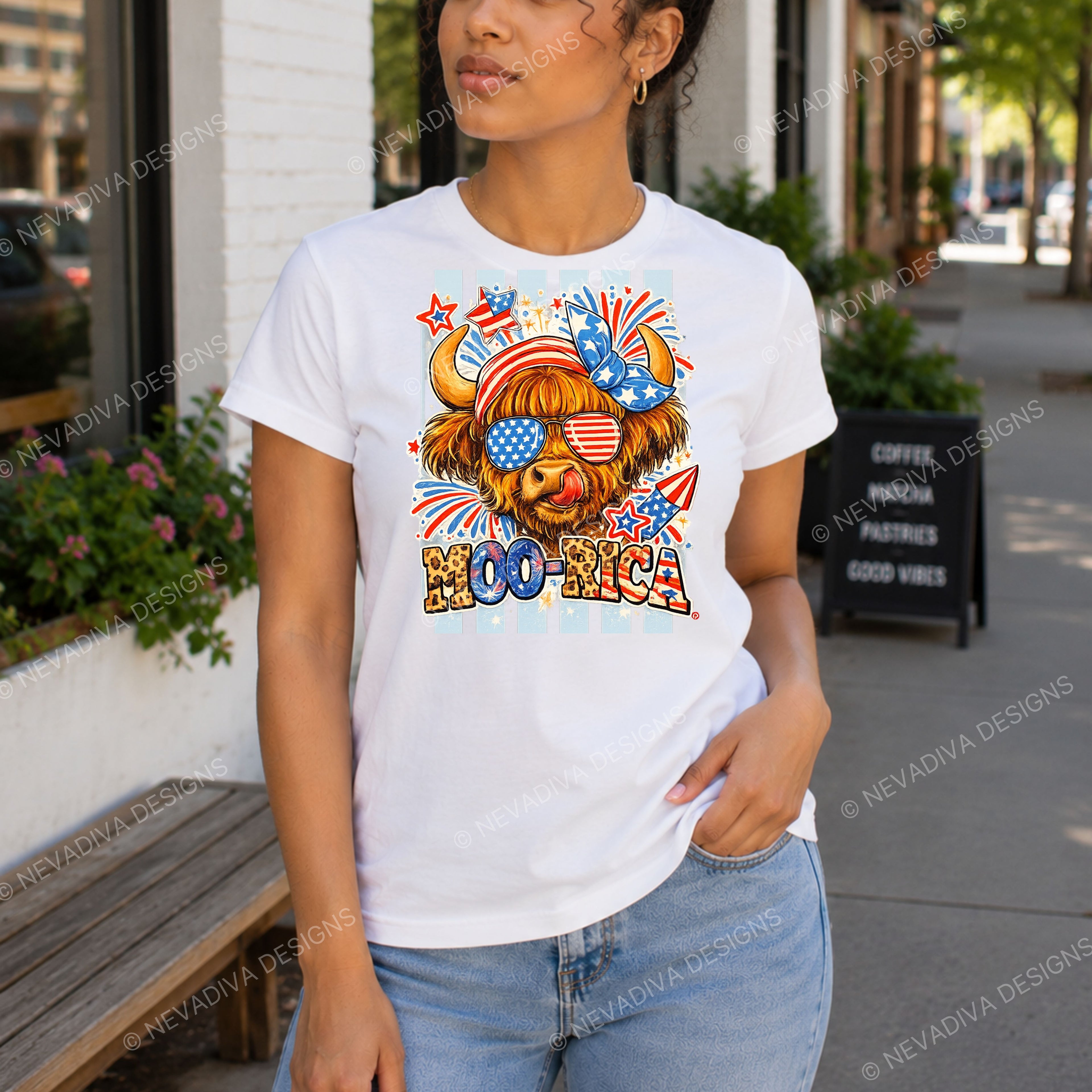 Person wearing a white t-shirt with a colorful graphic design outdoors.