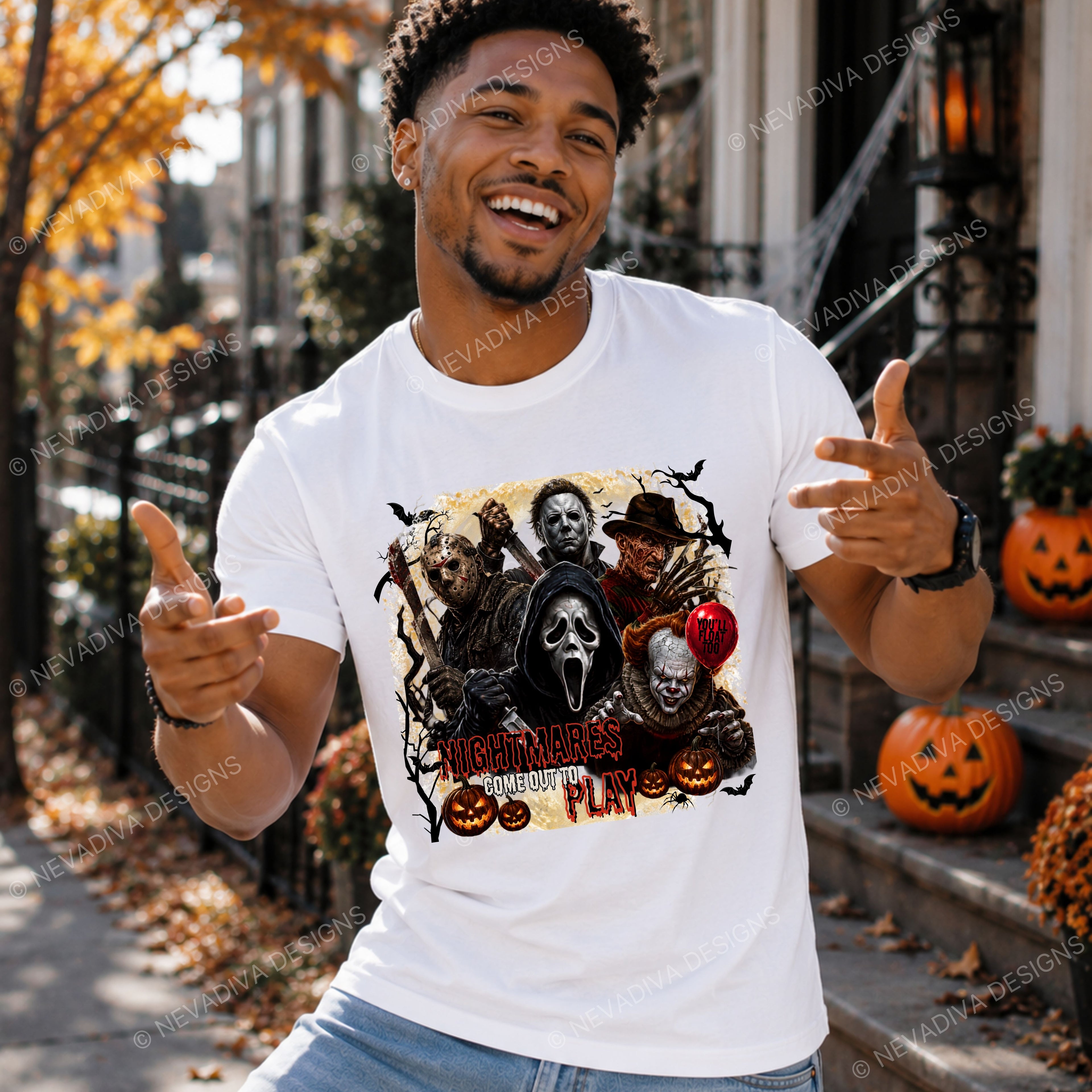 A man wearing a white graphic t-shirt featuring the 'Nightmares COME OUT TO Play' design from the movie Scream, posing outdoors on a Halloween-themed street with pumpkins and autumn leaves.