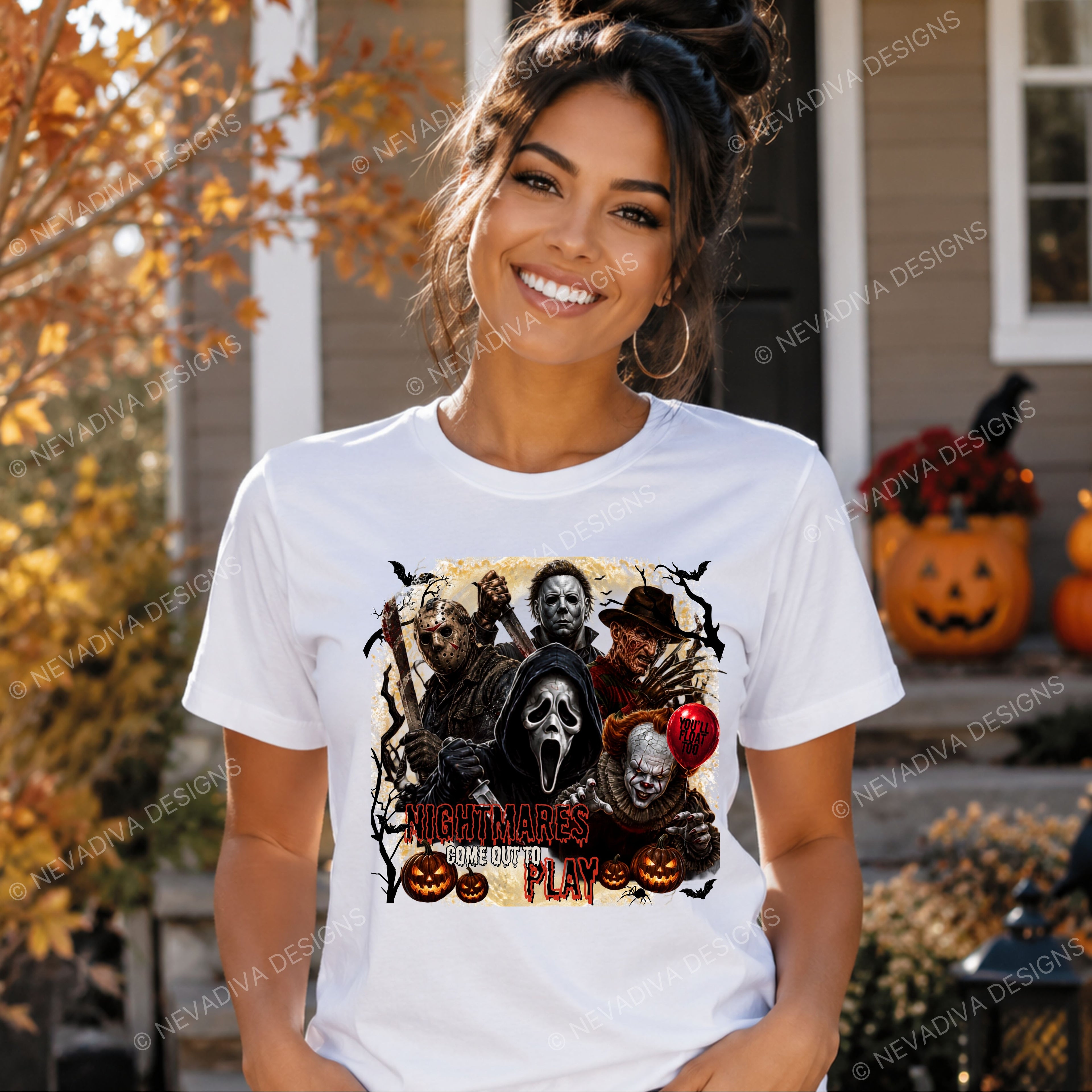 A woman wearing a white graphic t-shirt with a 'Nightmares COME OUT TO Play' Halloween design, standing in front of a house decorated for Halloween.