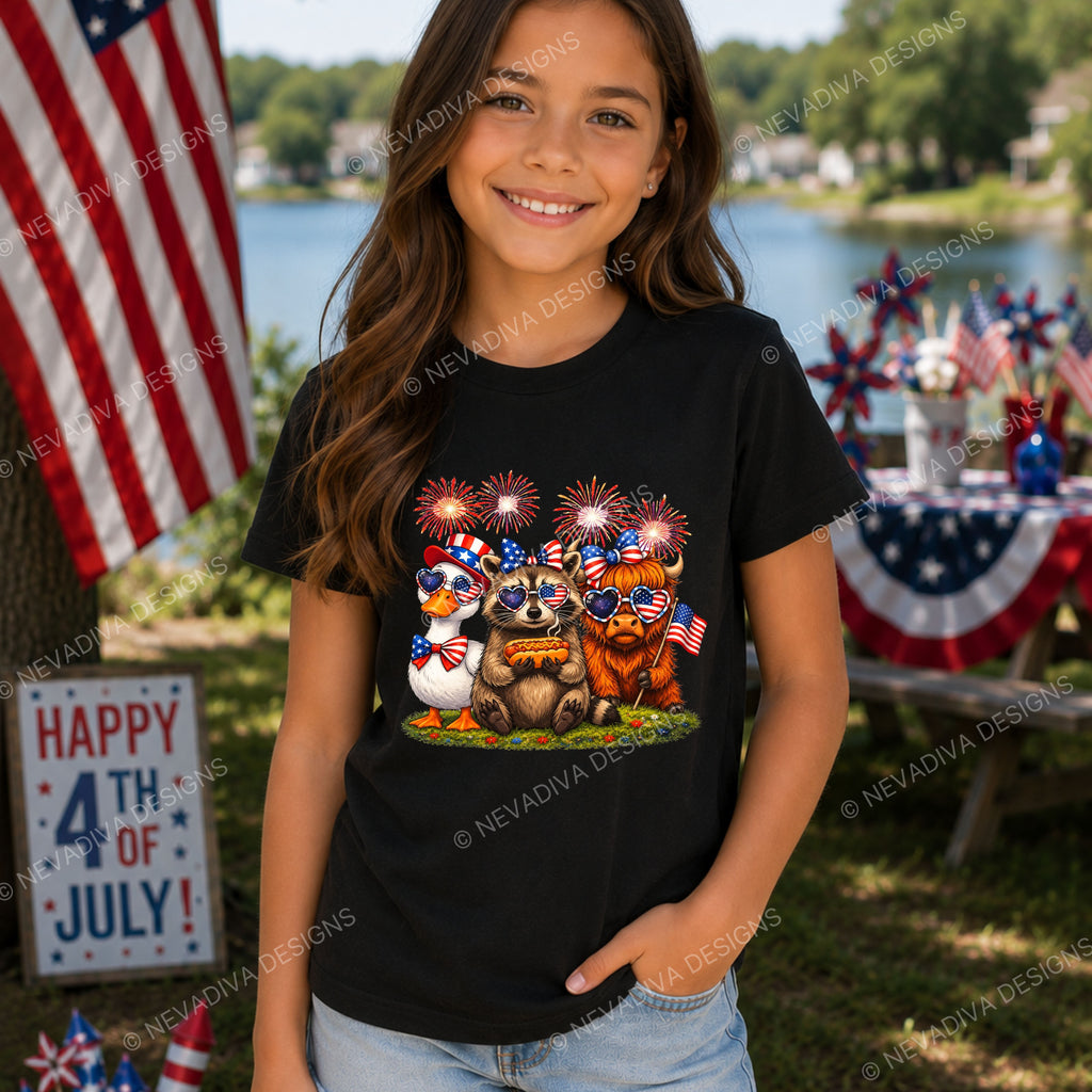 Girl wearing a black t-shirt with a 4th of July design, standing outdoors with a lake and American flag in the background.