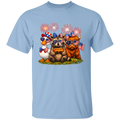 Light blue t-shirt with a design of bears, a duck, and a pumpkin with American flags and fireworks on a white background.