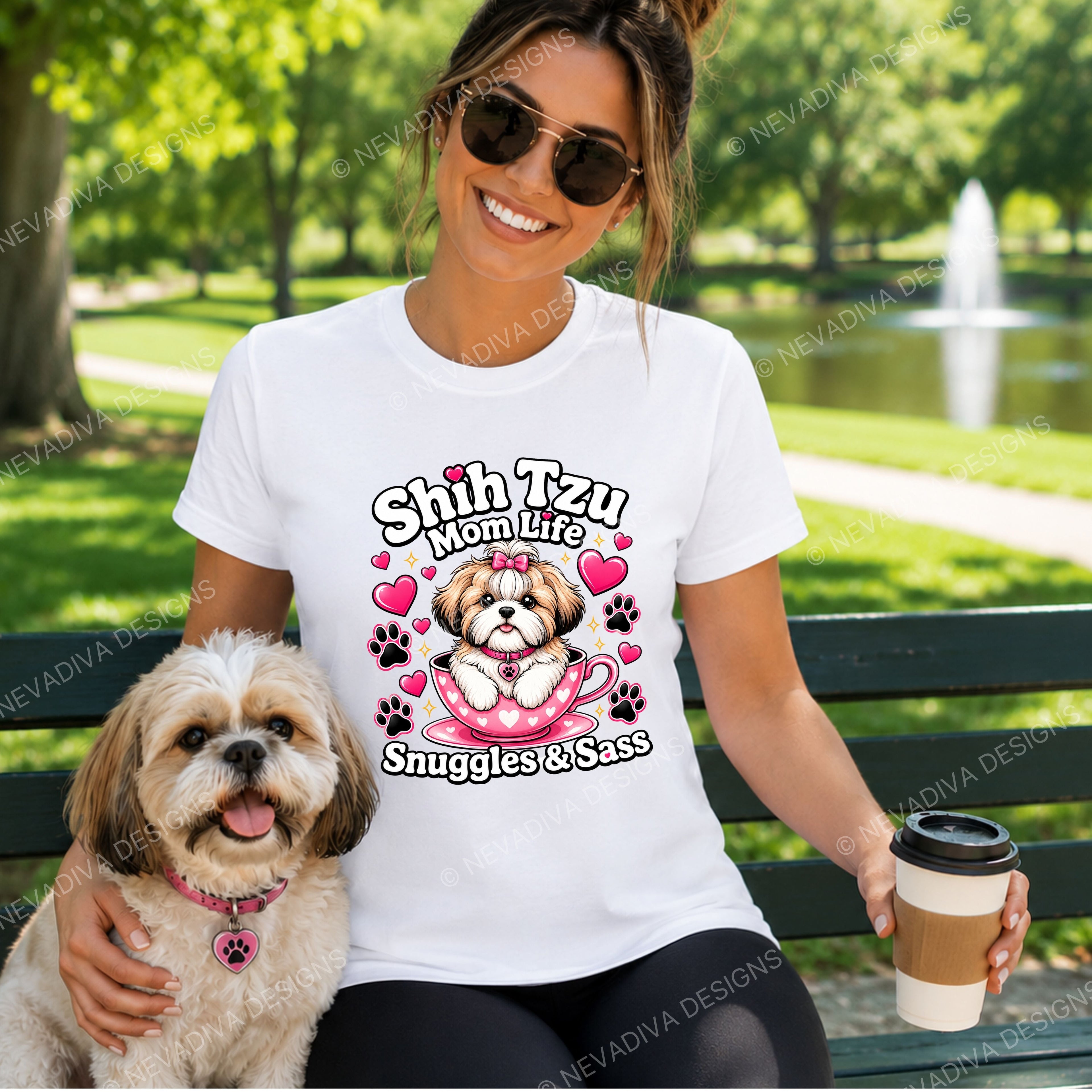women wearing a t shirt with her fur baby and text saying Shih Tzu Mom life while having coffee at the park with her furry friend.