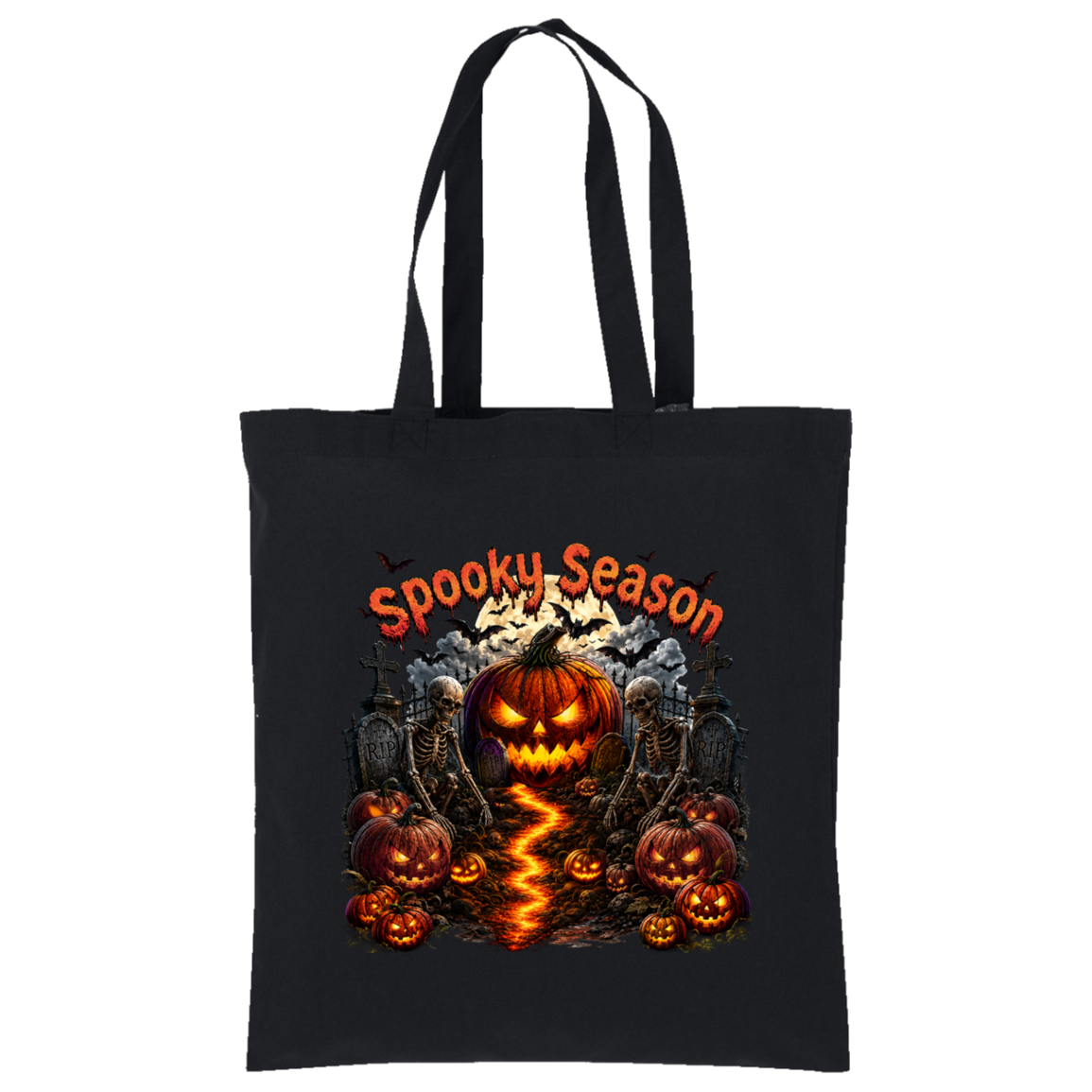 A black canvas tote bag with long black handles, featuring a colorful Halloween graphic on the front. The design includes the text 'Spooky Season' in orange, a glowing jack-o'-lantern in the center, smaller pumpkins, skeletons, tombstones, and a lightning strike effect on the ground, all set against a plain white background.