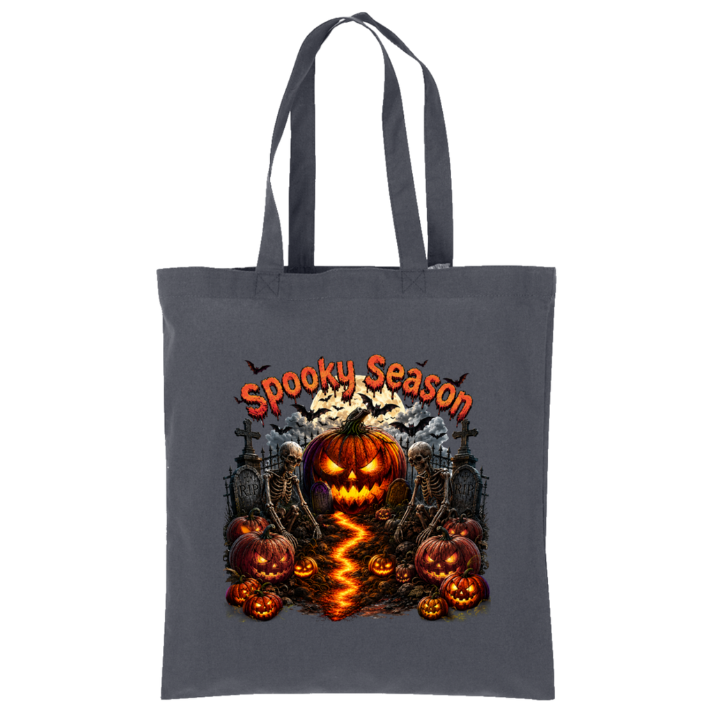 A dark gray canvas tote bag with a 'Spooky Season' Halloween graphic print featuring a jack-o'-lantern, skeletons, tombstones, and pumpkins on a white background.