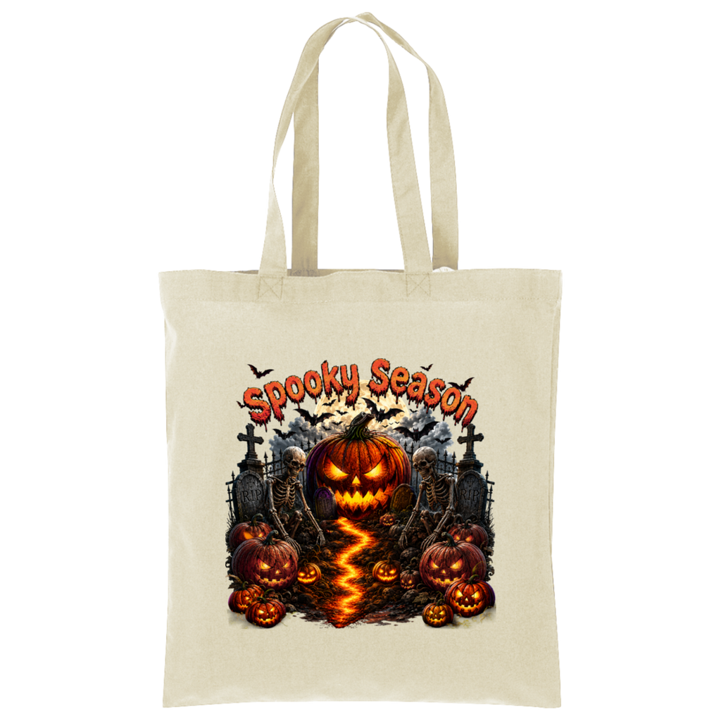 A natural canvas tote bag featuring a colorful Halloween graphic with a glowing jack-o'-lantern, skeletons, tombstones, bats, and the text 'Spooky Season' in orange.