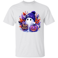 A white short-sleeve crewneck t-shirt featuring a colorful Halloween graphic on the chest. The graphic depicts a cute white ghost wearing a purple knit beanie, holding a glowing jack-o'-lantern, surrounded by autumn leaves and the text 'Trick or Treat'.