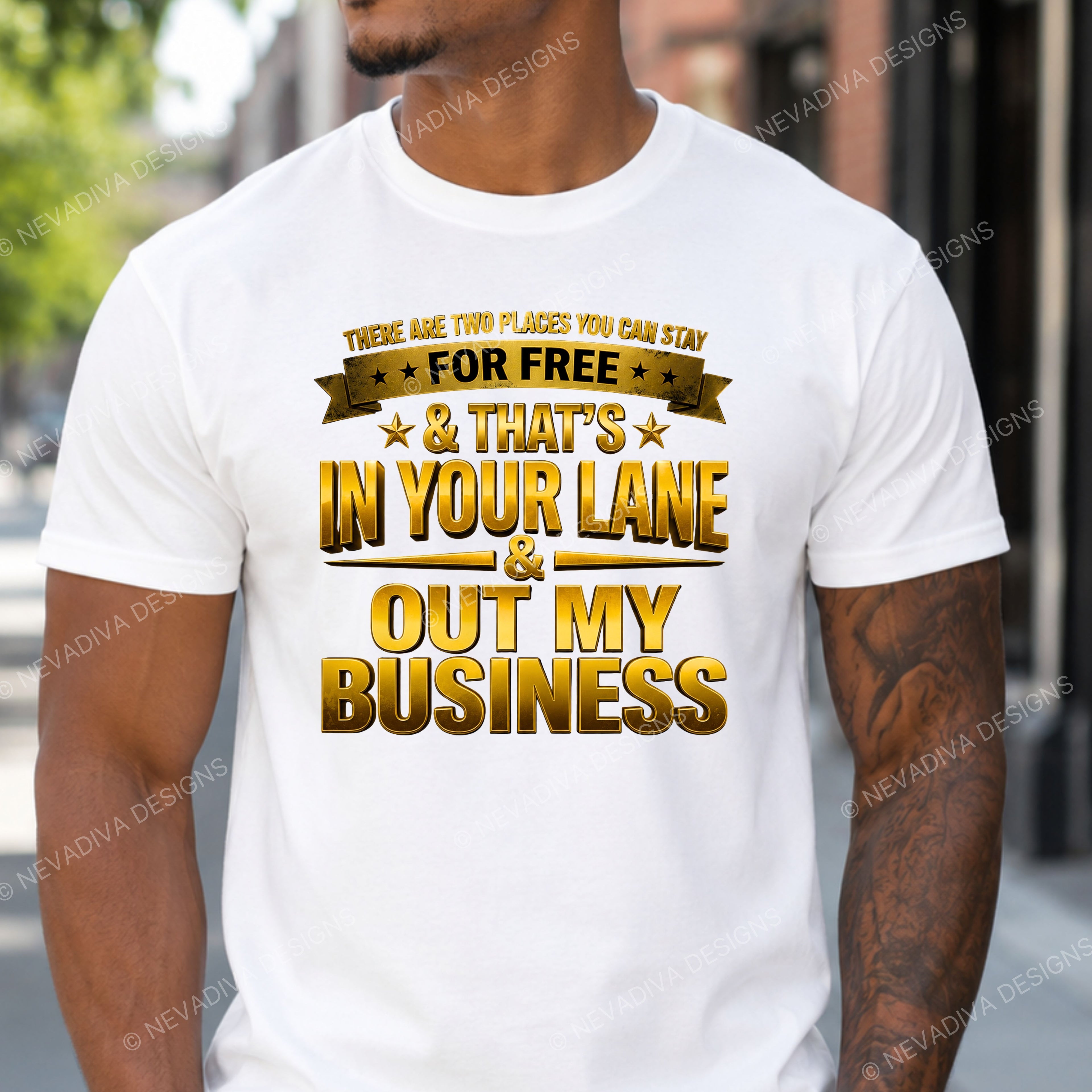 Person wearing a white t-shirt with gold text in an urban setting