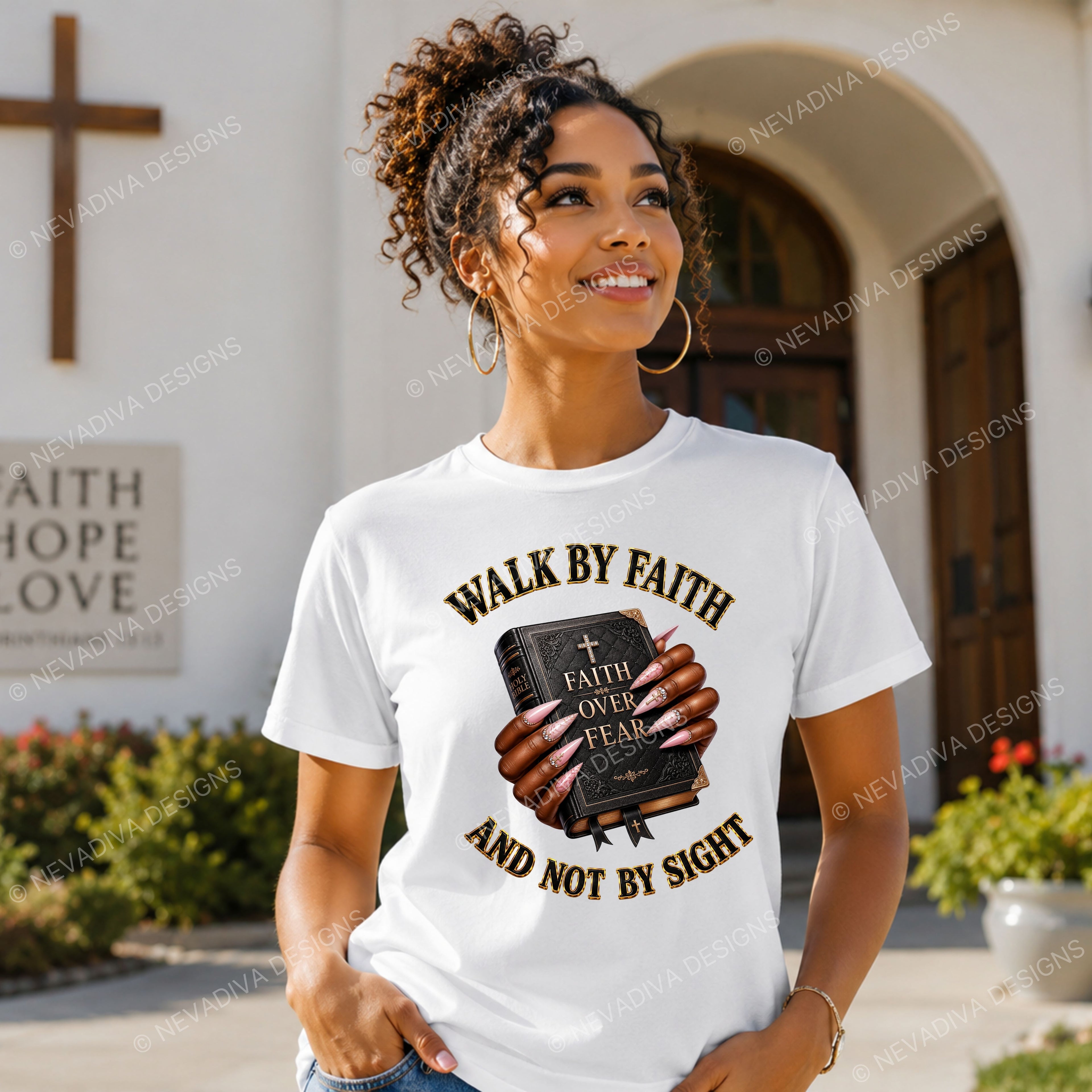 A woman wearing a white graphic t-shirt with a religious design that reads 'WALK BY FAITH AND NOT BY SIGHT' holding a Bible, standing in front of a church building.