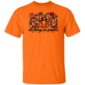 An orange short-sleeve crewneck t-shirt featuring a graphic on the chest with the text 'with GOD all things are possible' in autumn-themed lettering with pumpkins and leaves.