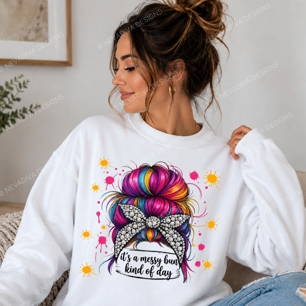 Woman wearing a white sweatshirt with a colorful bun design and text.