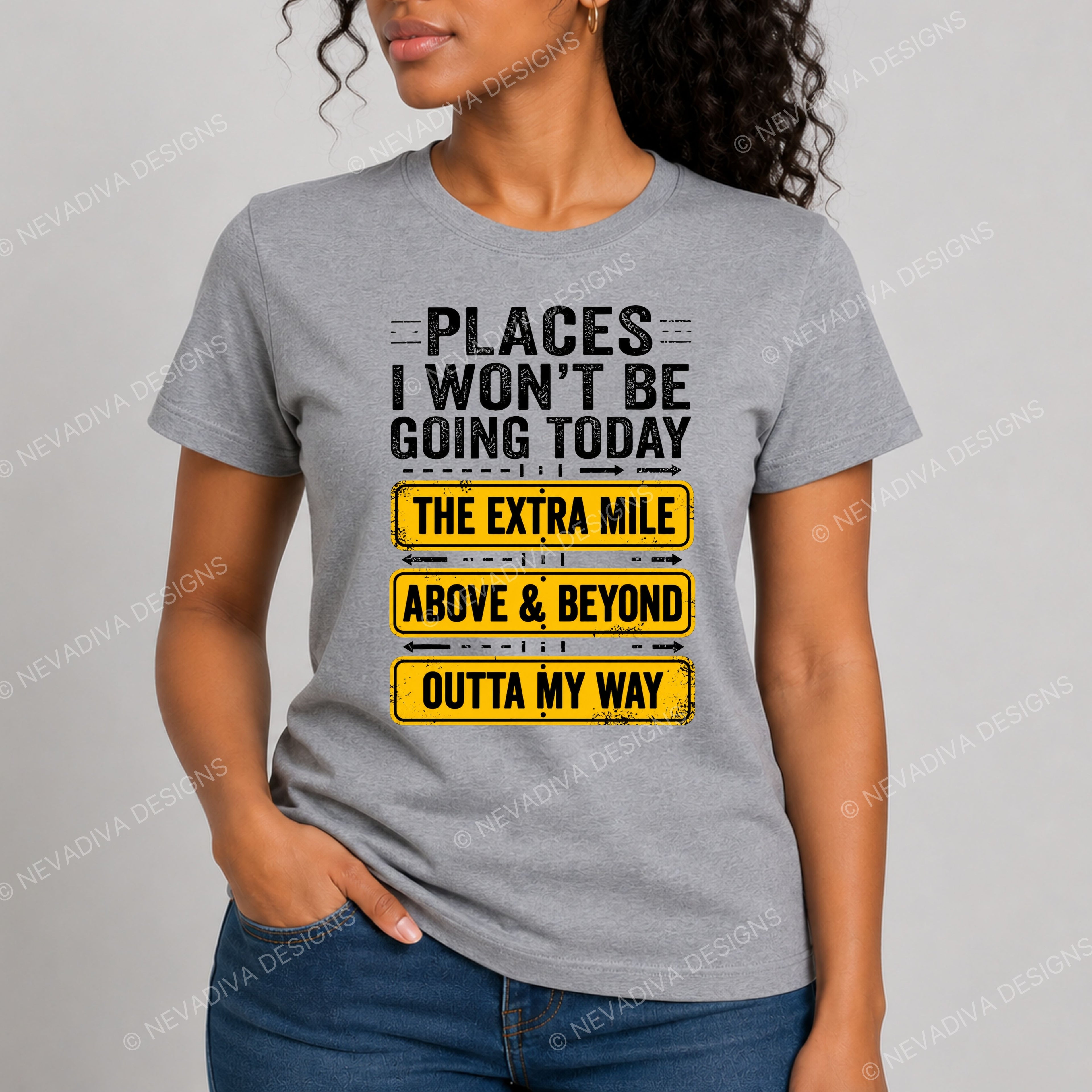 Person wearing a gray t-shirt with motivational text design on a plain background
